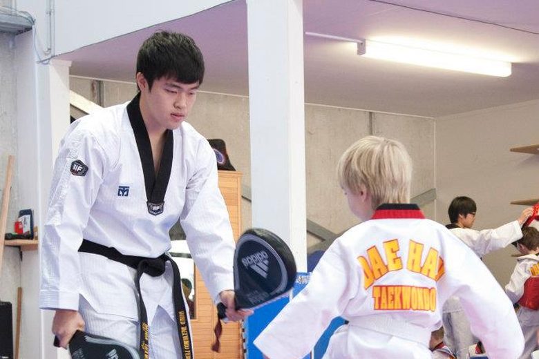 Instructor coaching a young student